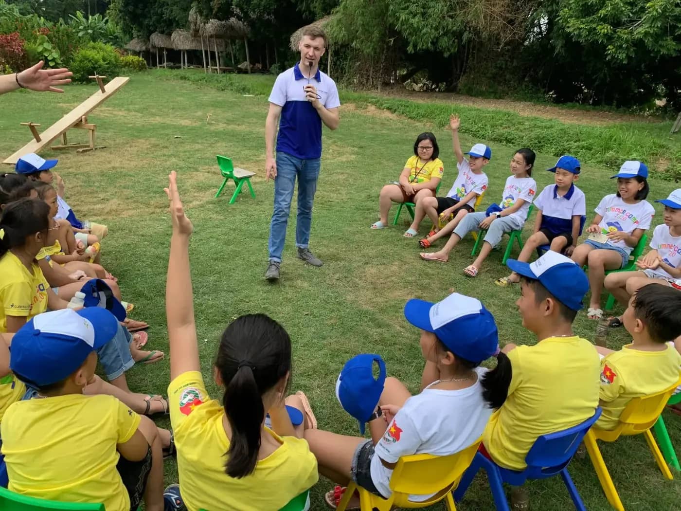 A native teacher leading an outdoor lesson at summer camp
