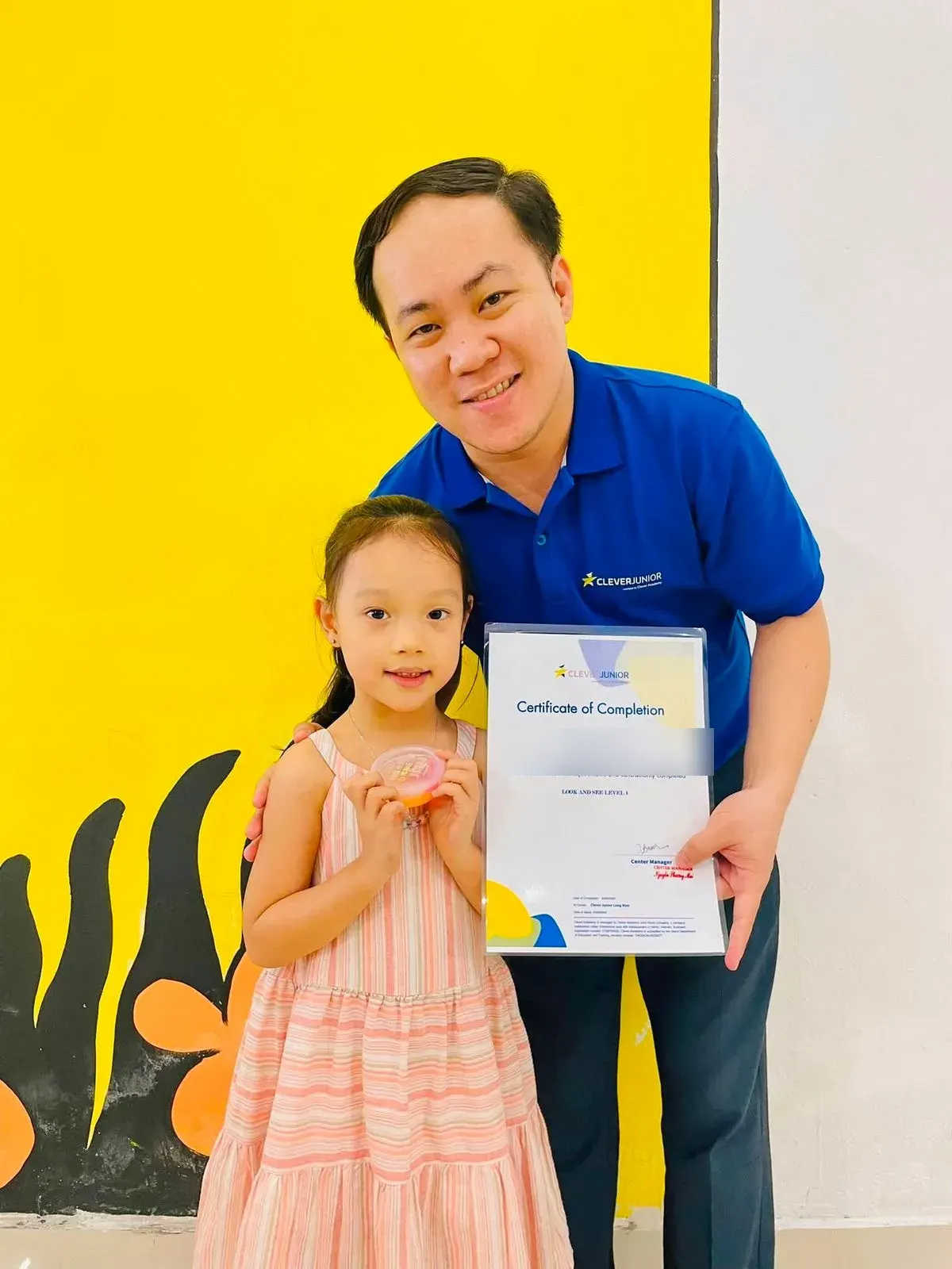 A student receiving a course completion certificate