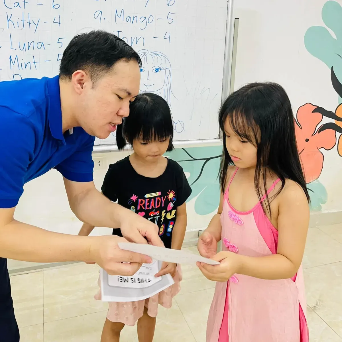 A teacher and a student looking at a worksheet together at Clever Junior Long Bien